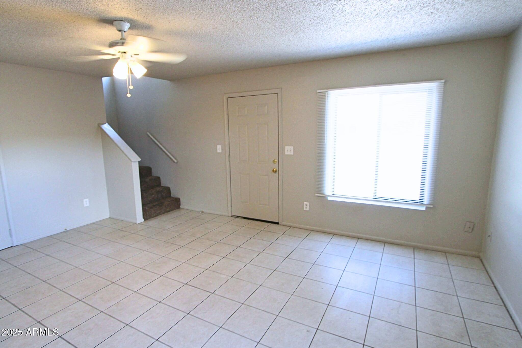 410 East 9th Avenue, Unit 1 Mesa, AZ 85204 - Photo 3 of 17 a view of an empty room with a window