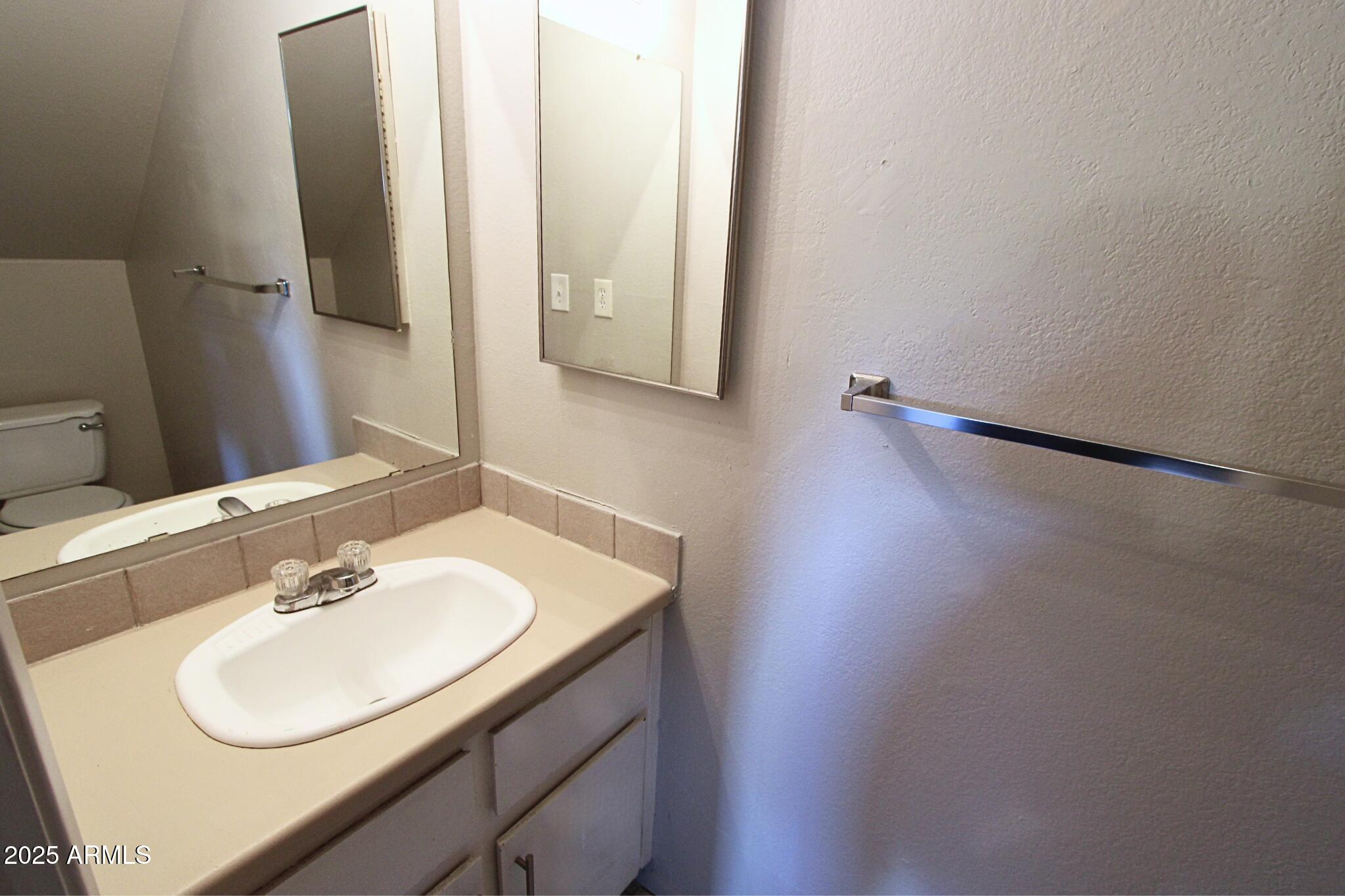 410 East 9th Avenue, Unit 1 Mesa, AZ 85204 - Photo 10 of 17 a bathroom with a sink and a mirror