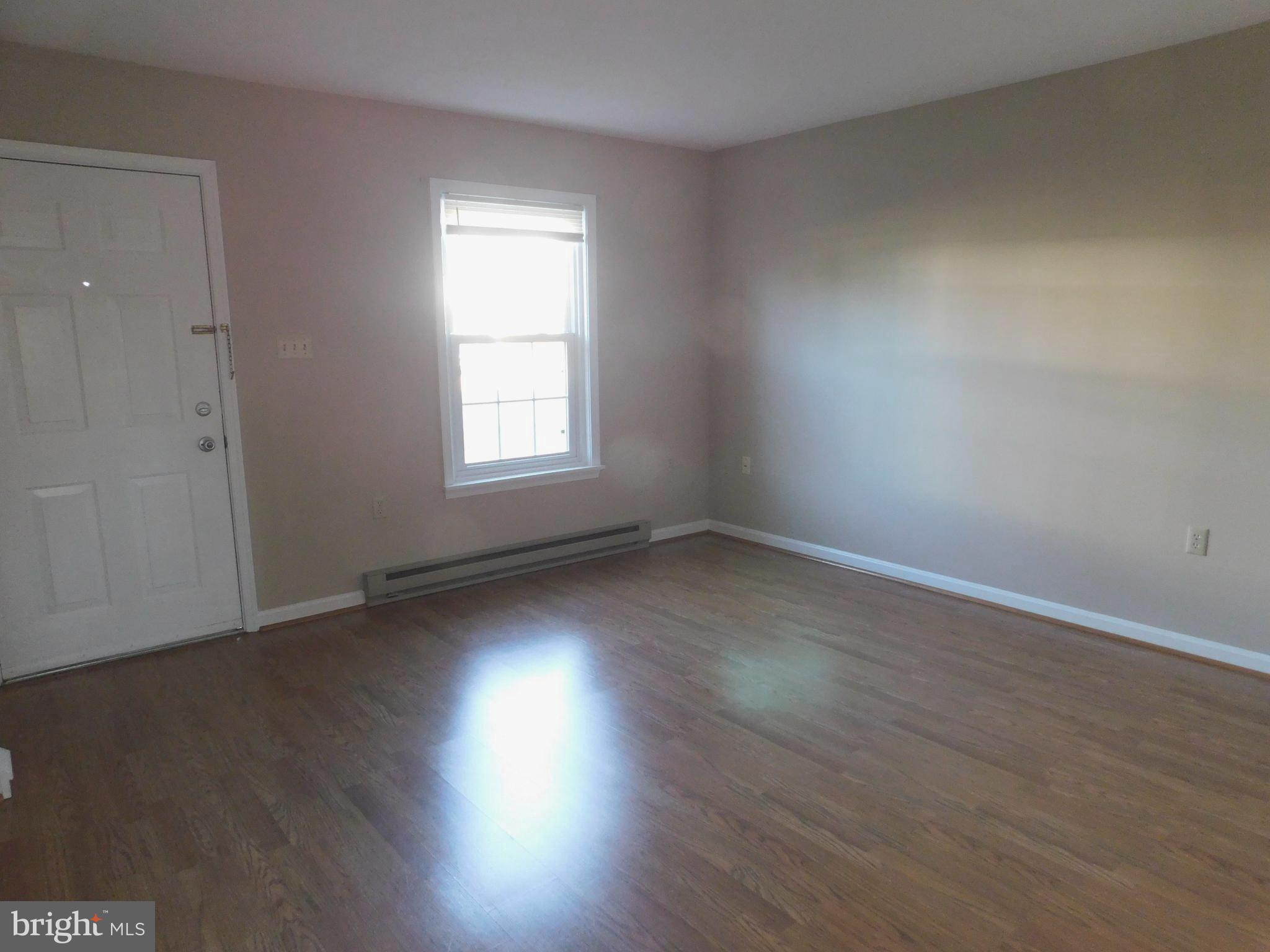 2918 Packer Street Winchester, VA 22601 - Photo 1 of 12 an empty room with wooden floor and windows
