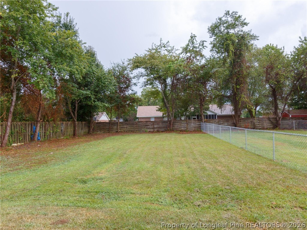 115 Eulon Loop, Unit A Raeford, NC 28376 - Photo 14 of 16 a small yard with trees