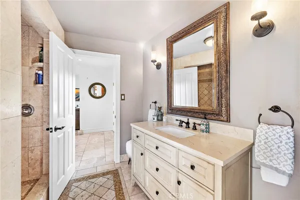 a large kitchen with kitchen island a large counter top space appliances and cabinets