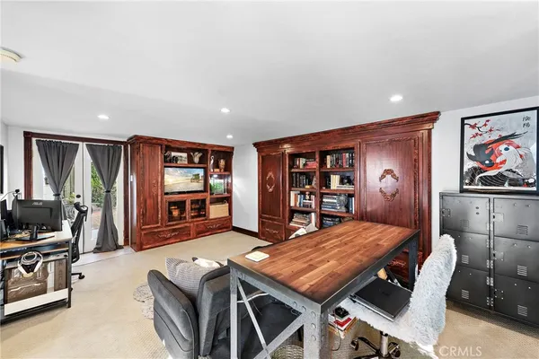 a kitchen with stainless steel appliances wooden floor dining table and chairs