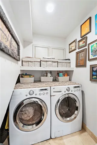 a kitchen with stainless steel appliances granite countertop a refrigerator a stove a sink and a microwave