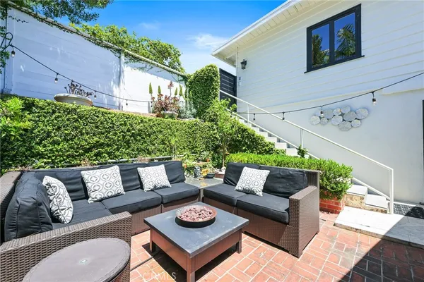 an outdoor view of a house with a potted plant