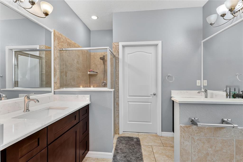 1938 Commander Way Kissimmee, FL 34746 - Photo 13 of 30 a bathroom with a sink and a mirror