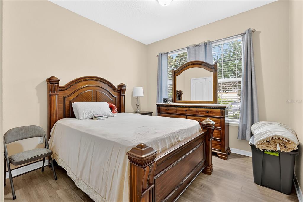 1938 Commander Way Kissimmee, FL 34746 - Photo 14 of 30 a bedroom with a bed and a dresser