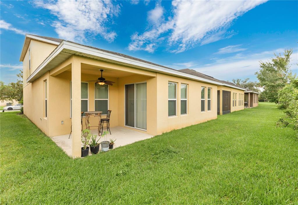 1938 Commander Way Kissimmee, FL 34746 - Photo 18 of 30 a view of a house with a yard porch and sitting area
