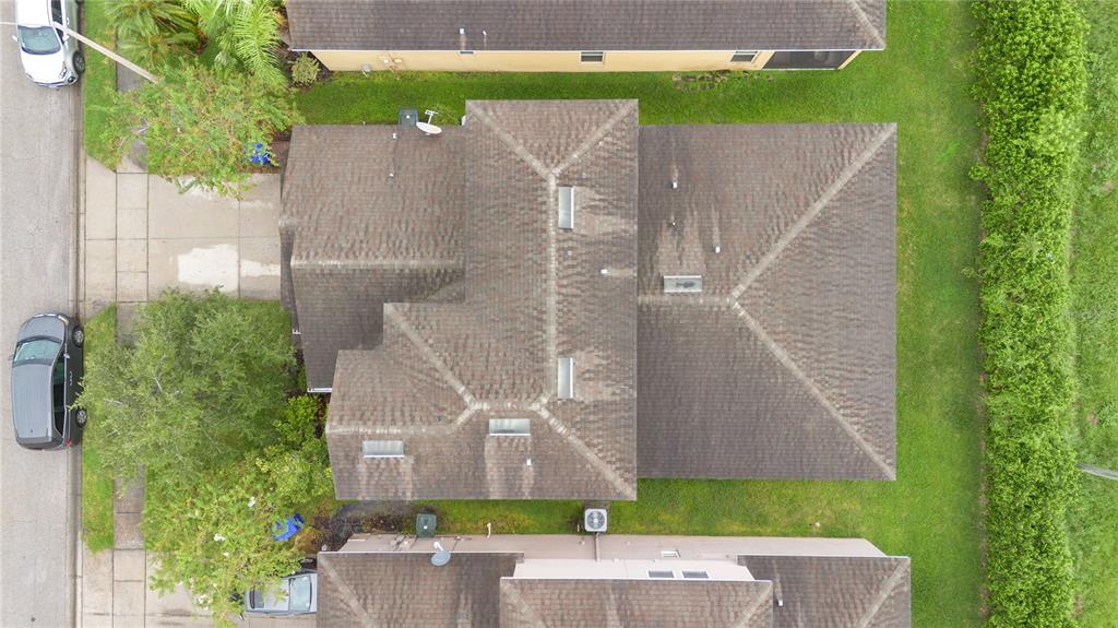 1938 Commander Way Kissimmee, FL 34746 - Photo 22 of 30 an aerial view of a house with a yard and large trees
