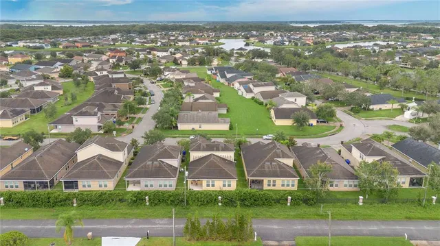 an aerial view of residential houses with outdoor space and swimming pool