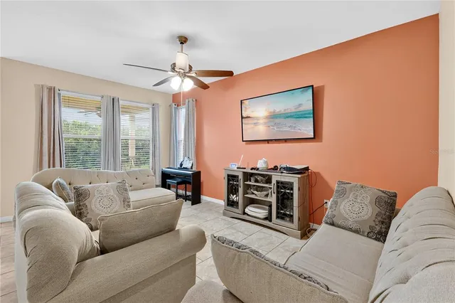 a living room with furniture and a large window