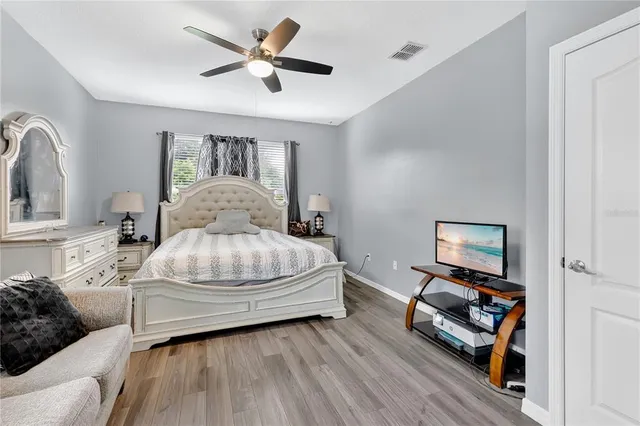 a bedroom with a bed and wooden floor