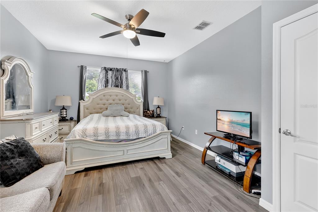 1938 Commander Way Kissimmee, FL 34746 - Photo 10 of 30 a bedroom with a bed and wooden floor