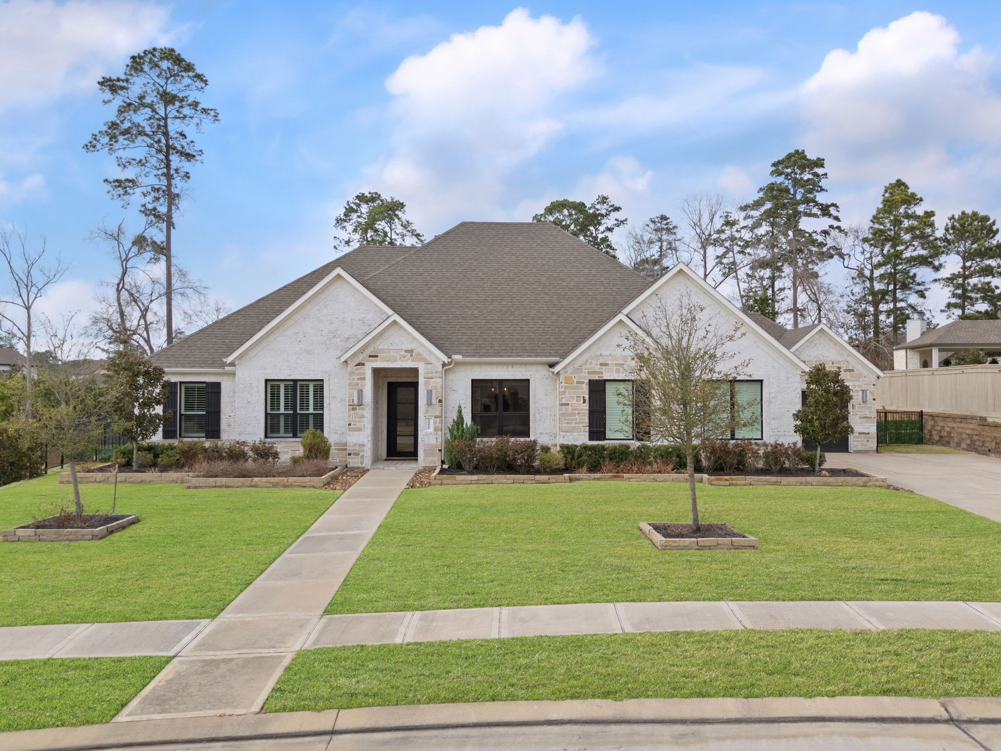 14019 Beartooth Bend Trail Conroe, TX 77384 - Photo 2 of 28 DR Horton Emerald series one-story home with striking brick and stone elevation, manicured landscaping, and exceptional curb appeal.