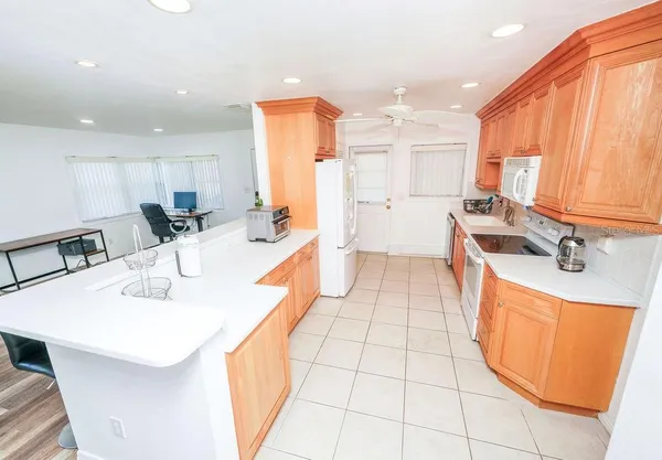 a kitchen with stainless steel appliances kitchen island granite countertop a sink and cabinets