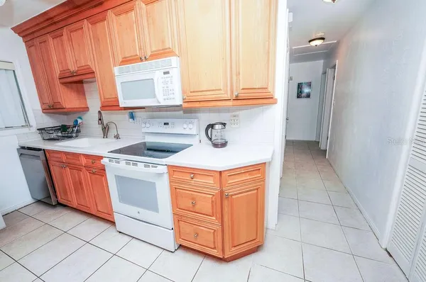 a kitchen with stainless steel appliances granite countertop a sink and a cabinets