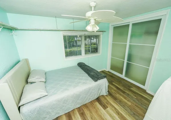 a spacious bedroom with a bed and a window