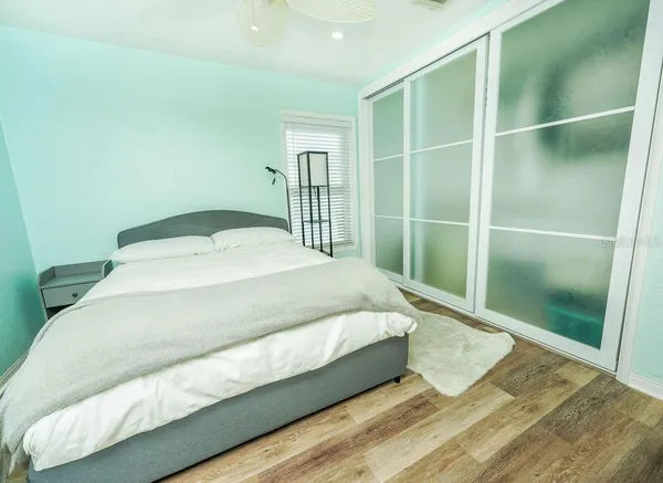 a large bed sitting in a bedroom next to a window