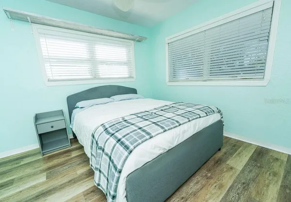 a bedroom with a bed and a window
