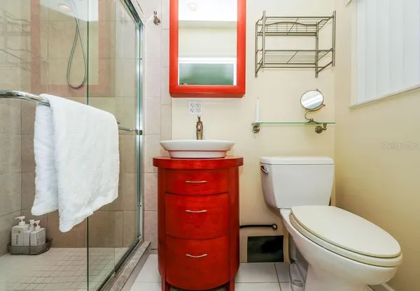 a white toilet sitting next to a bathroom sink