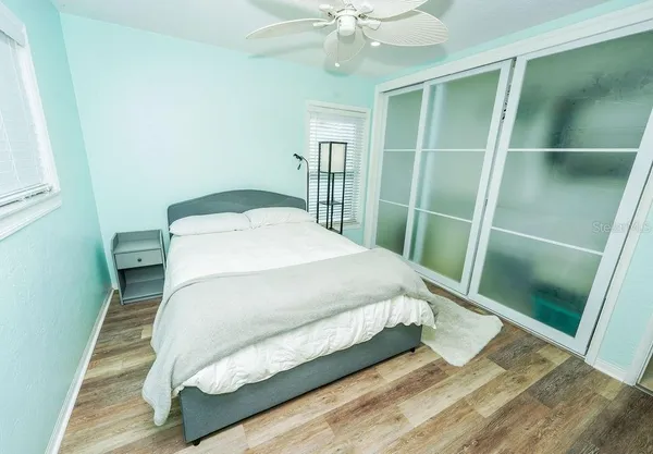 a bed sitting in a bedroom next to a window