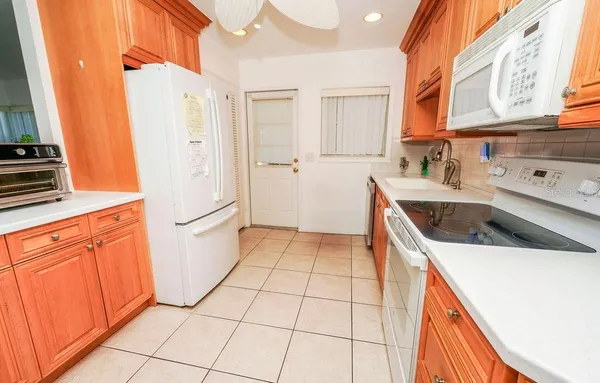 a kitchen with a sink a stove and a refrigerator