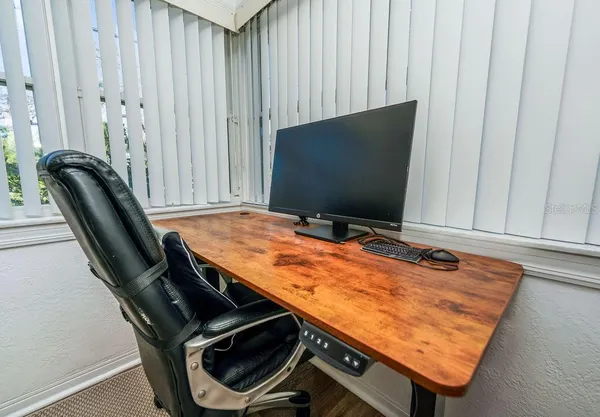 a sitting area with furniture and wooden floor