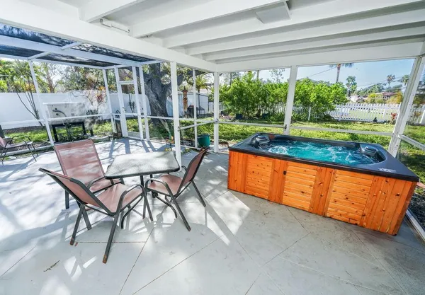 a view of a patio with a table chairs and a backyard