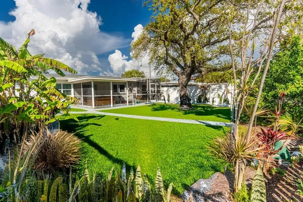 a front view of a house with garden