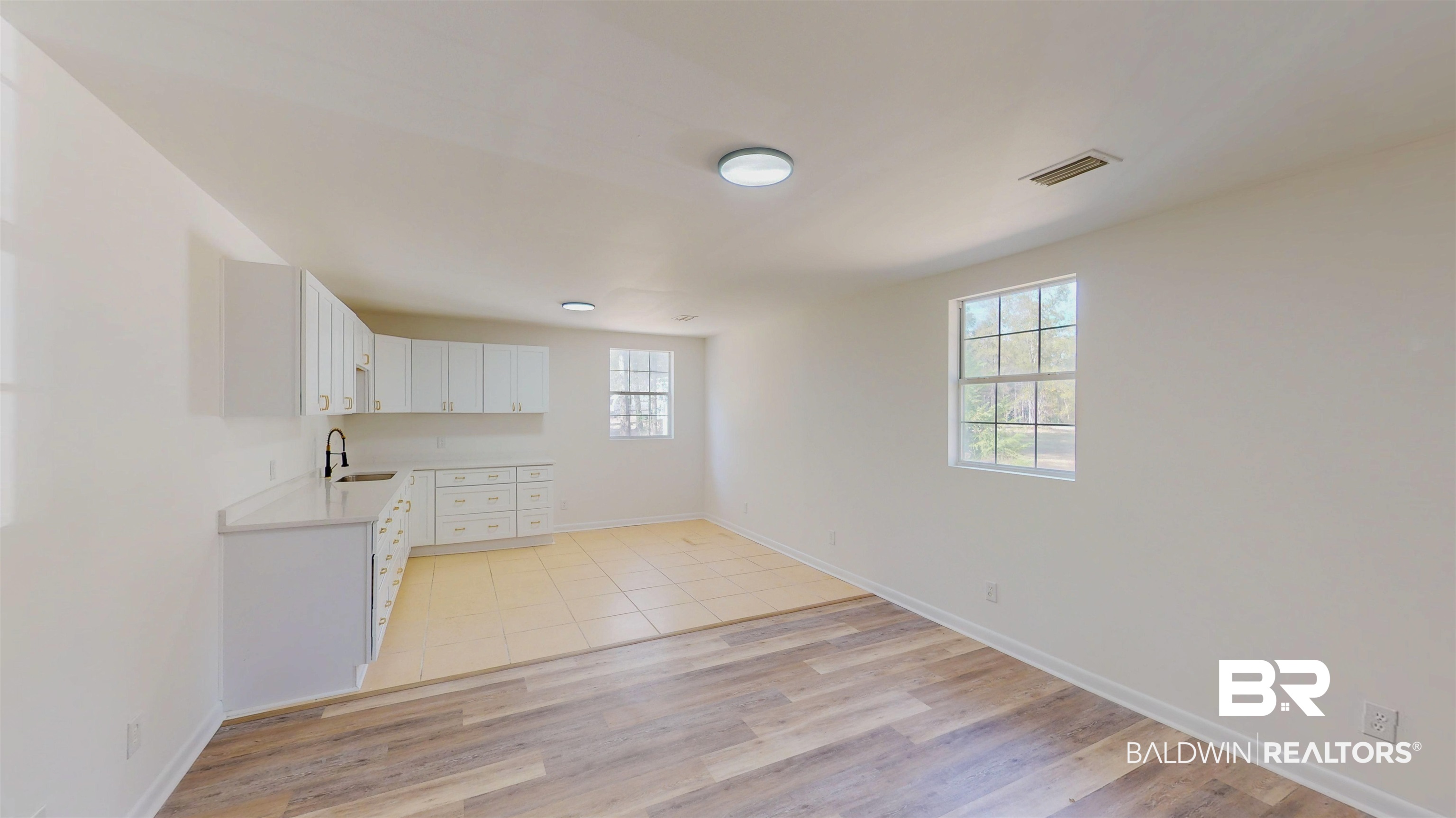 22711 Highway 98 Foley, AL 36535 - Photo 36 of 74 Unfurnished living room with light wood-type flooring and baseboards