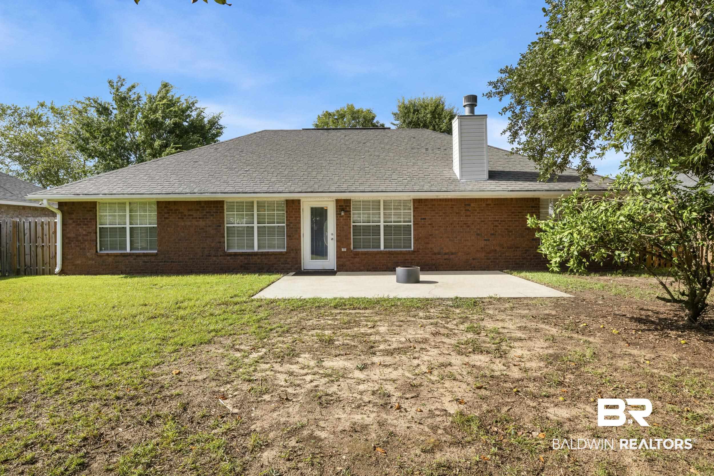 9610 Watkins Drive Fairhope, AL 36532 - Photo 22 of 26 Back of property featuring a patio and a yard