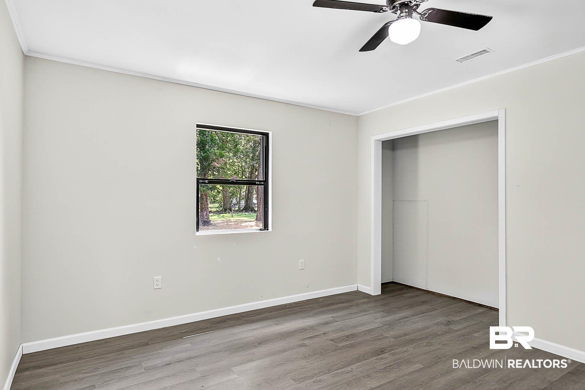 101 Terry Avenue Brewton, AL 36426 - Photo 47 of 48 Unfurnished bedroom featuring crown molding, wood finished floors, a closet, and a ceiling fan