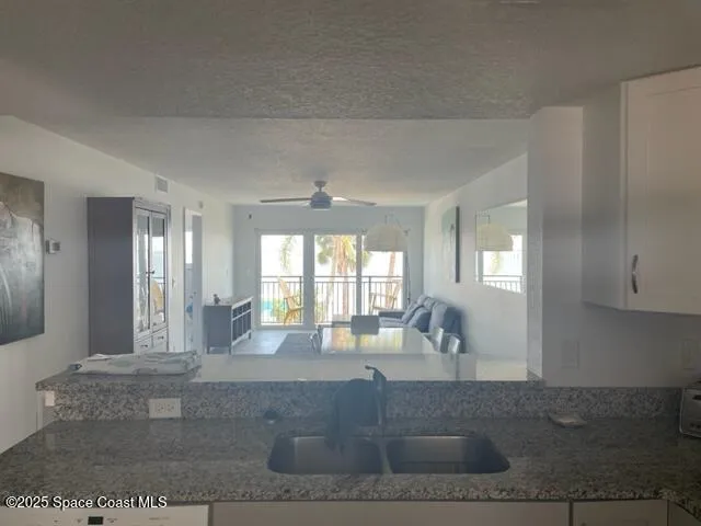 a living room with furniture and large windows