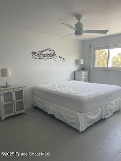 3901 Dixie Highway Northeast, Unit 210 Palm Bay, FL 32905 - Photo 6 of 9 a bedroom with a bed and a ceiling fan
