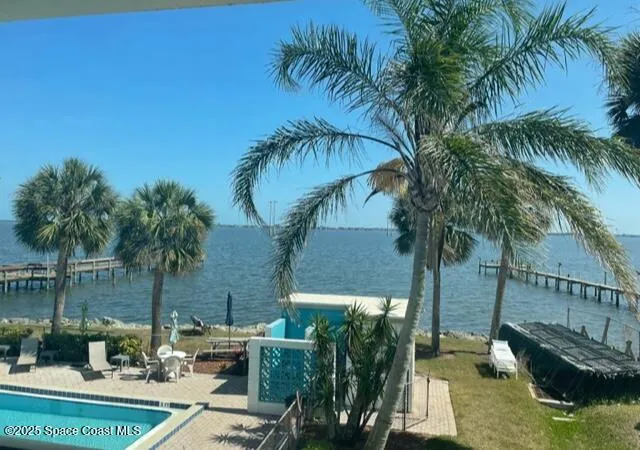 a view of swimming pool with a patio and a garden