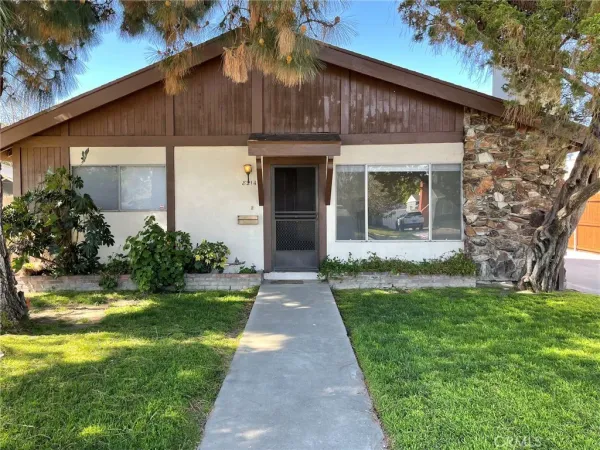 a front view of a house with garden