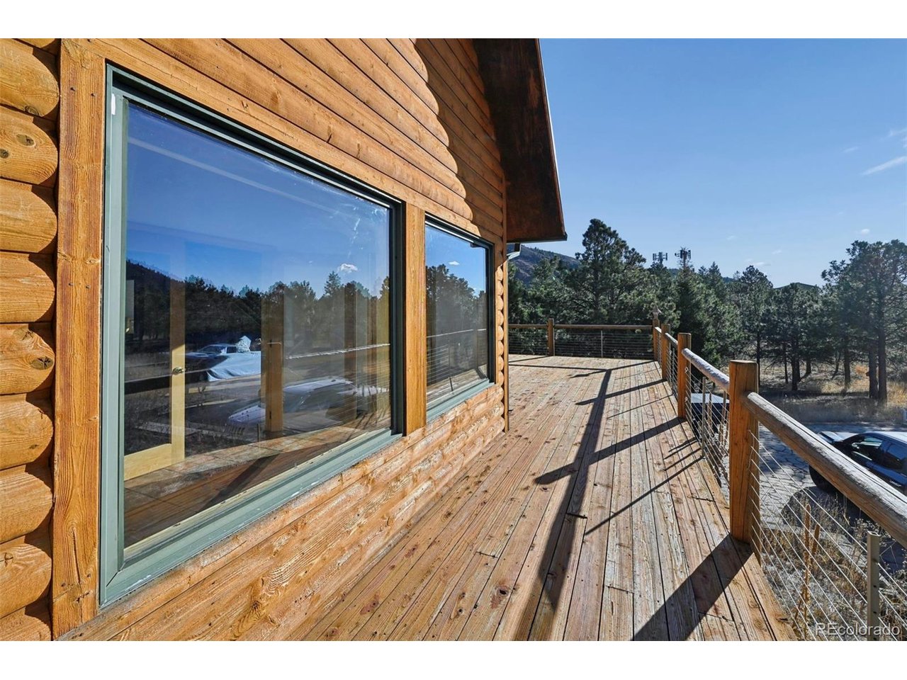 7415 West Highway 24 Cascade, CO 80809 - Photo 26 of 45 a balcony with view of car parked