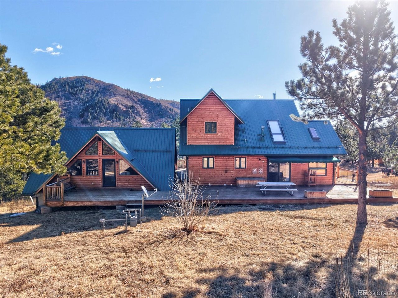 7415 West Highway 24 Cascade, CO 80809 - Photo 6 of 45 a front view of a house with a yard covered in snow