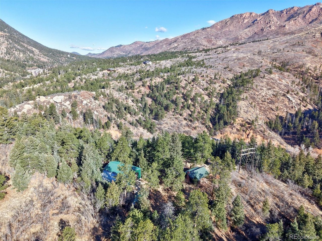 7415 West Highway 24 Cascade, CO 80809 - Photo 10 of 45 a view of a forest with mountains in the background
