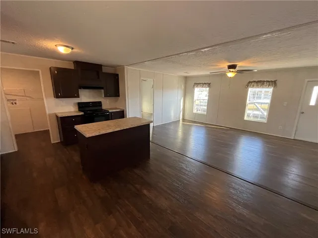 a large kitchen with lots of counter space a sink and appliances