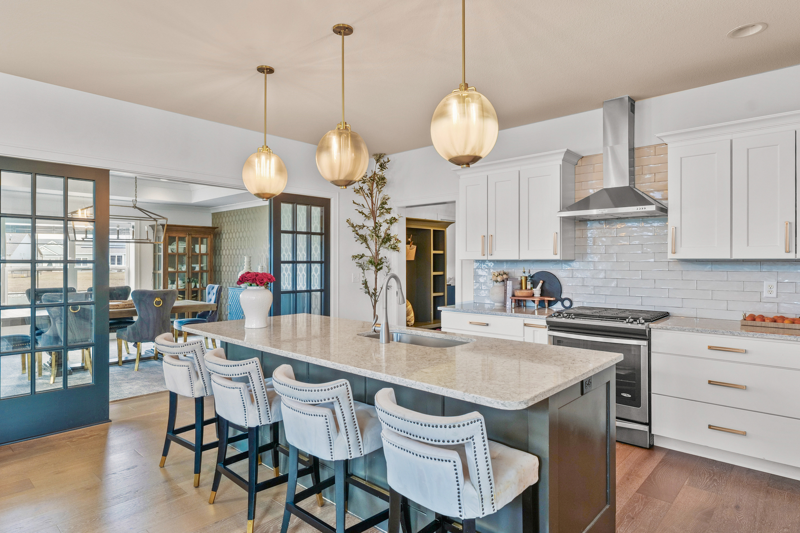 3901 Freedom Boulevard Champaign, IL 61822 - Photo 16 of 55 a kitchen with a dining table a stove a dining table and chairs with wooden floor
