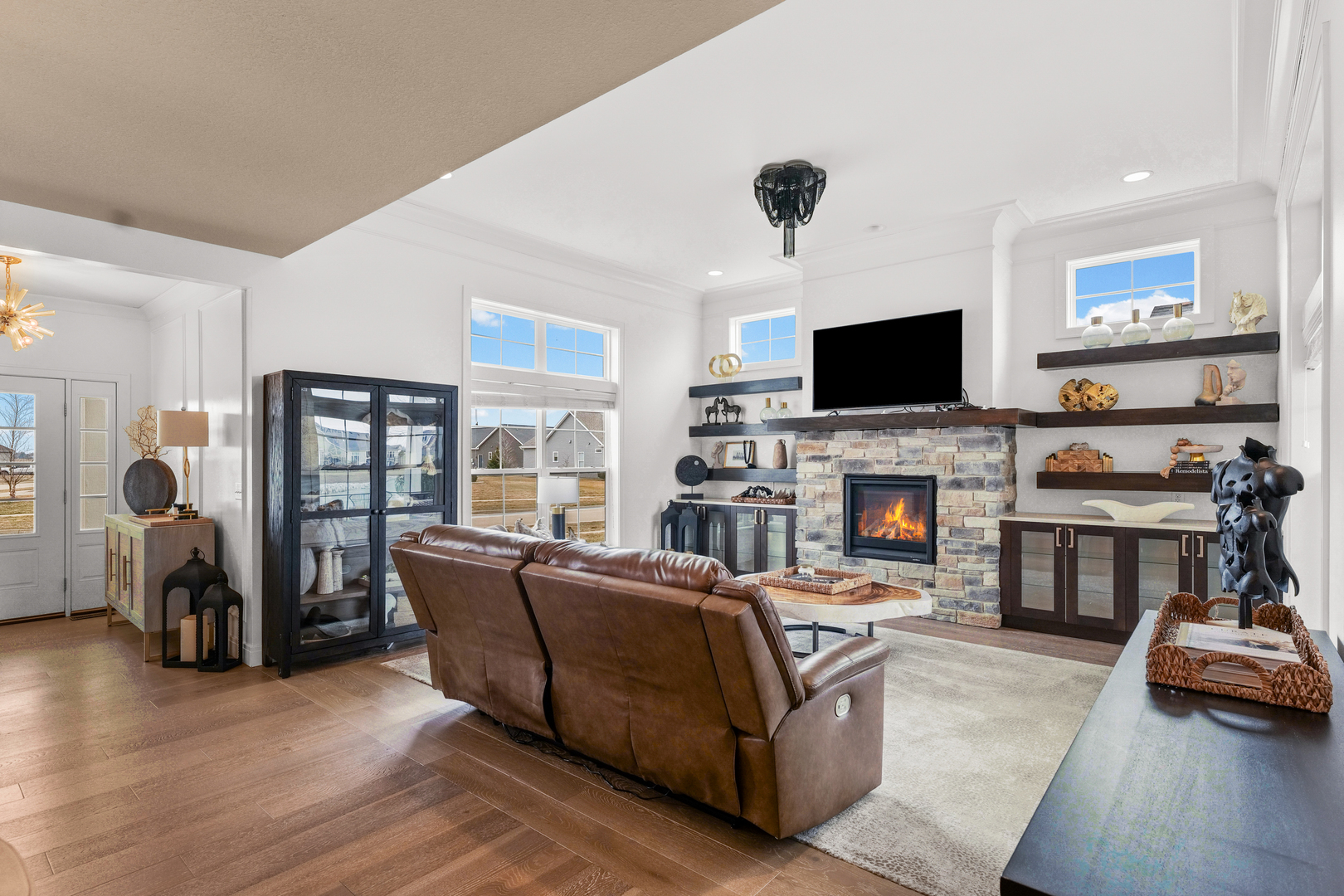 3901 Freedom Boulevard Champaign, IL 61822 - Photo 10 of 55 a living room with furniture a fireplace and a flat screen tv