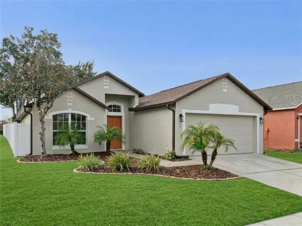 a front view of house with yard and green space