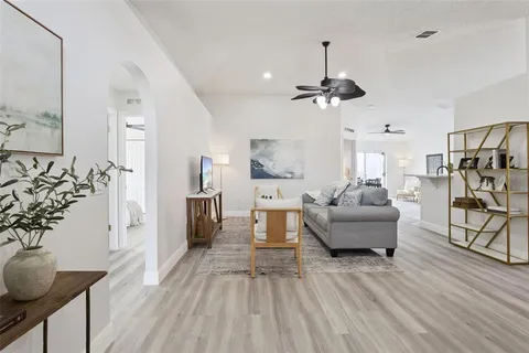a living room with furniture and a chandelier