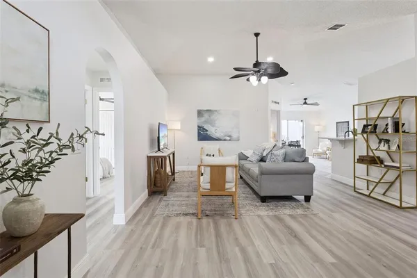 a living room with furniture and a chandelier
