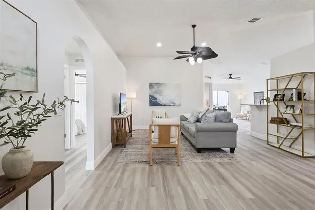 a living room with furniture and a chandelier