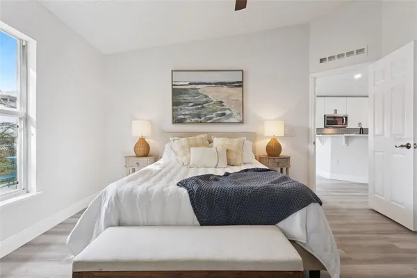 a bedroom with a bed and a painting on the wall