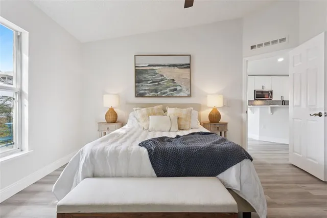 a bedroom with a bed and a painting on the wall