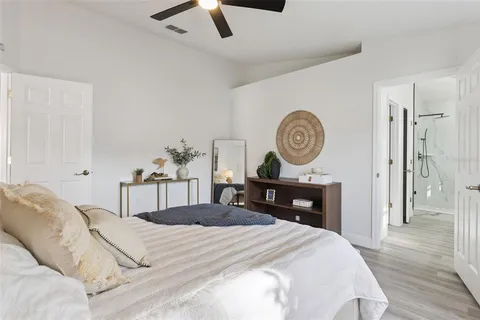 a bedroom with a bed and a chandelier