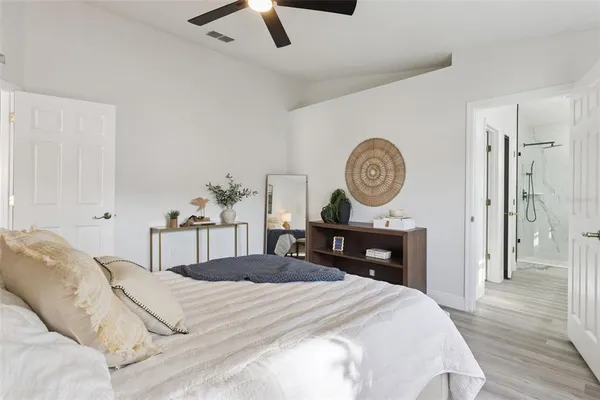 a bedroom with a bed and a chandelier