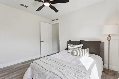 a bedroom with a bed and a ceiling fan